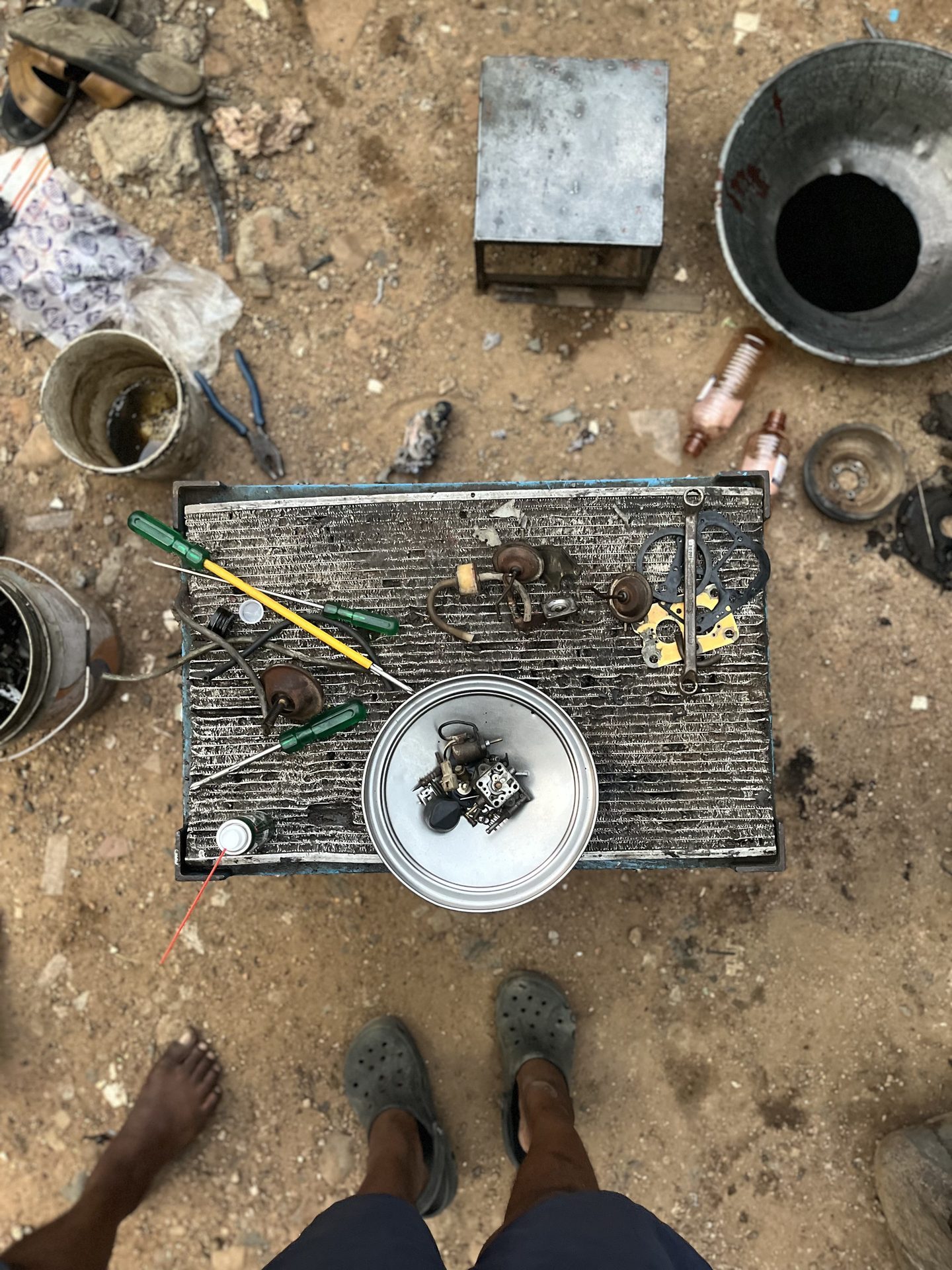 Birds-eye view of disassembled car parts on ground